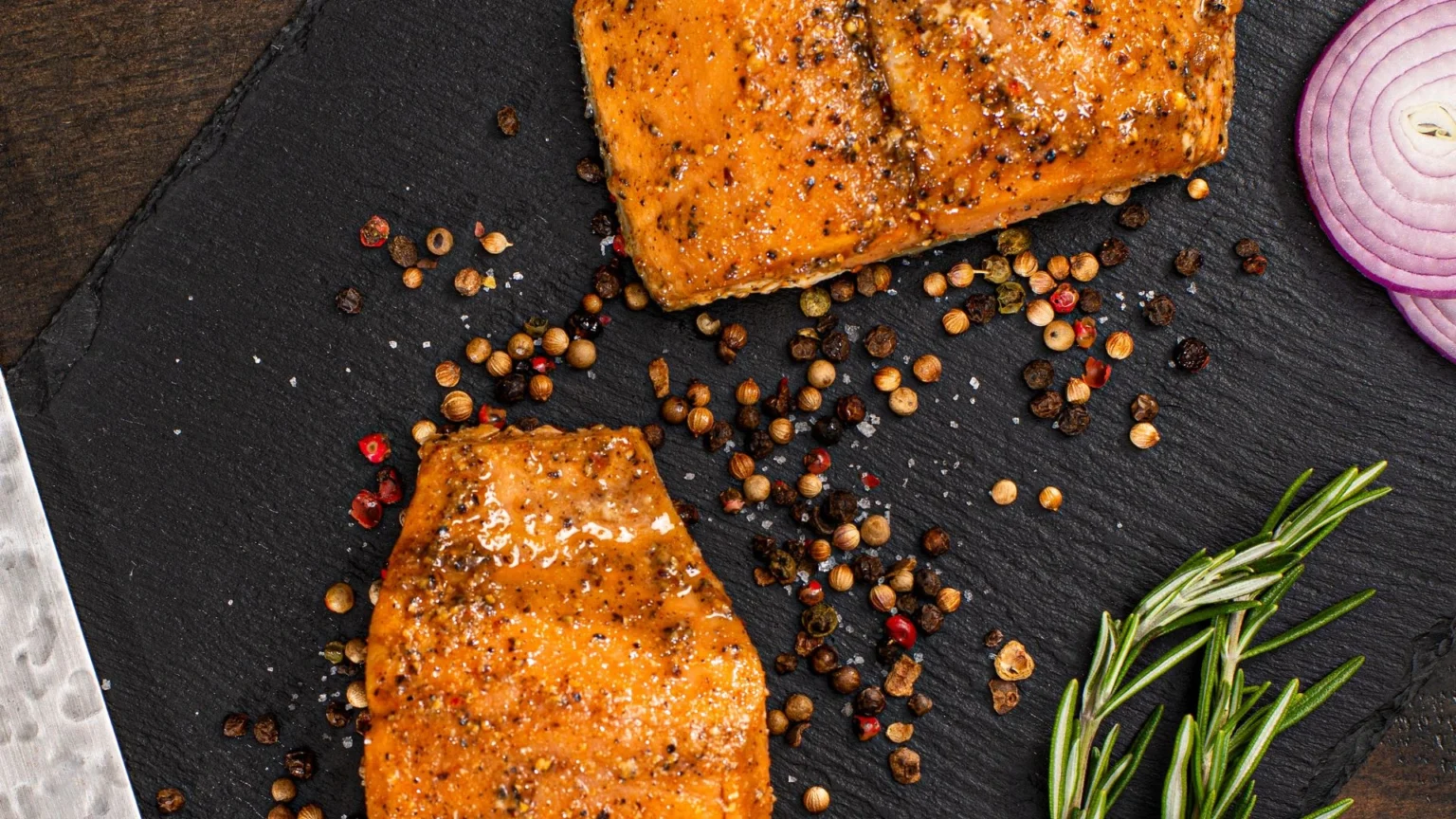 Seasoned grilled salmon on a cutting board